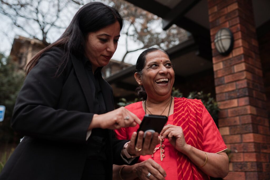 Two women using a phone