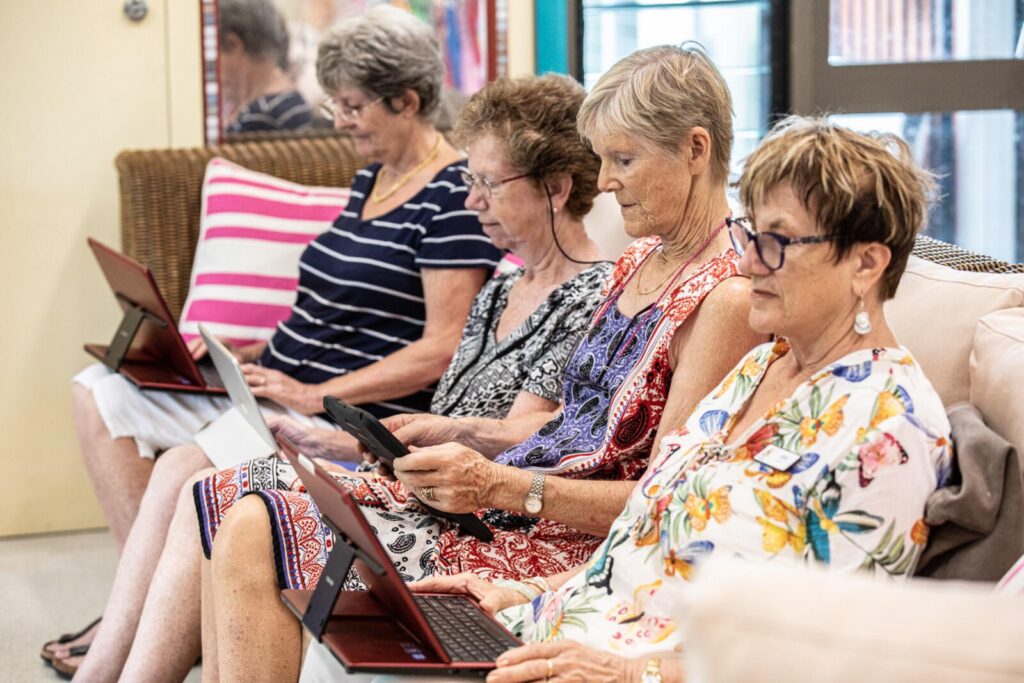 Women on couch using laptops