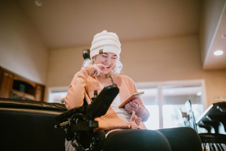 Young woman in a wheelchair on phone