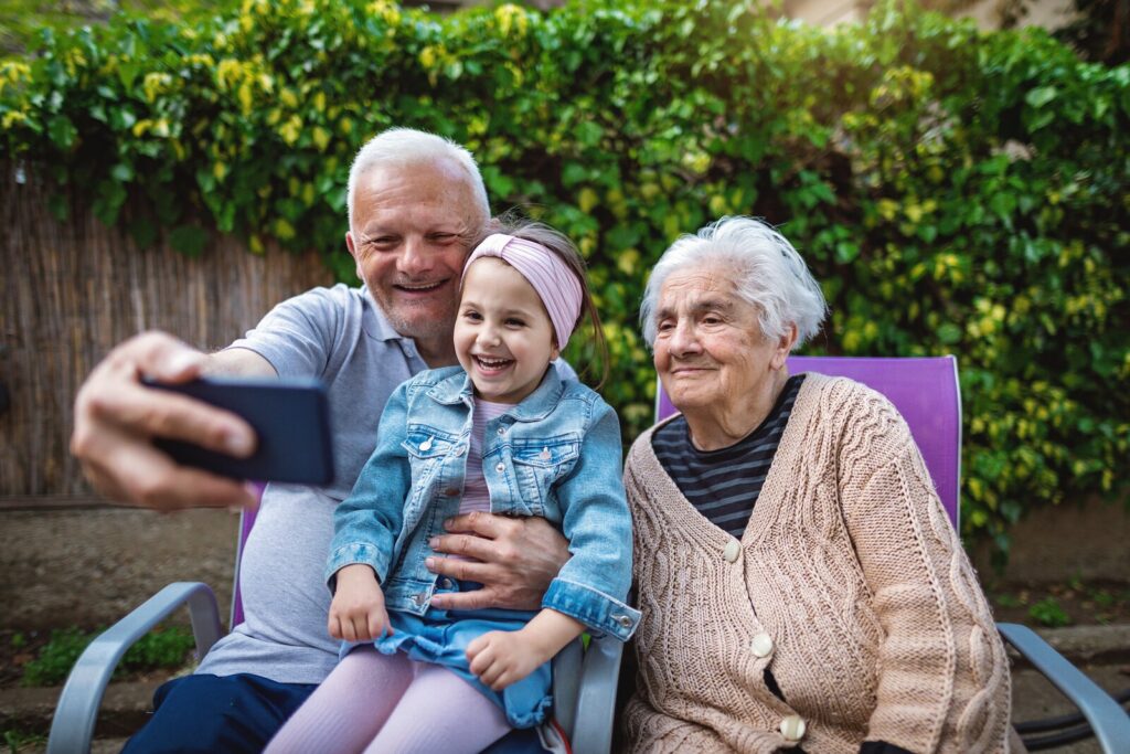 An old couple with her grandchild taking a selfie